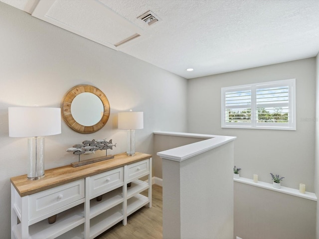 corridor with light hardwood / wood-style flooring