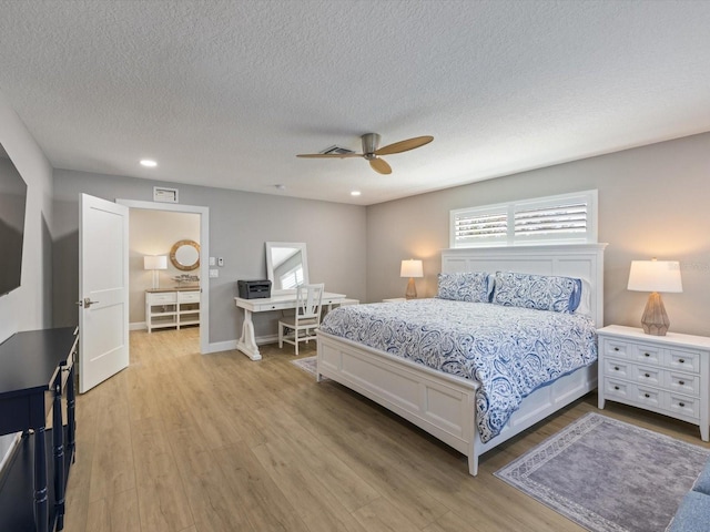 bedroom with a textured ceiling, light hardwood / wood-style flooring, and ceiling fan