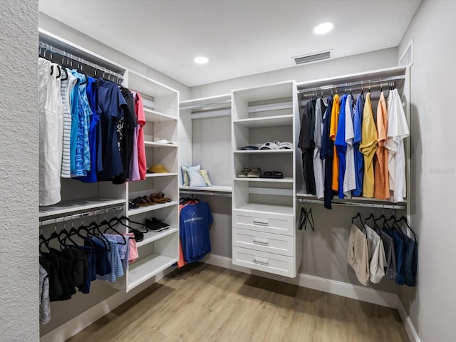 walk in closet featuring light hardwood / wood-style flooring