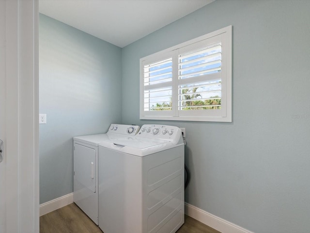 laundry room featuring wood-type flooring and washer and clothes dryer