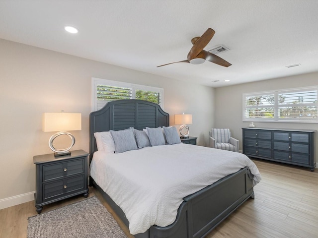 bedroom with light hardwood / wood-style floors and ceiling fan