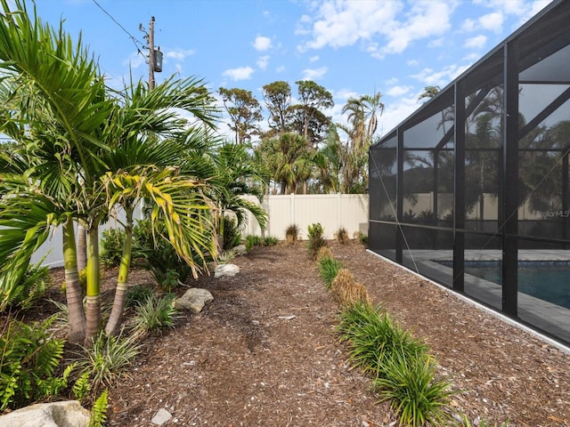 view of yard with glass enclosure