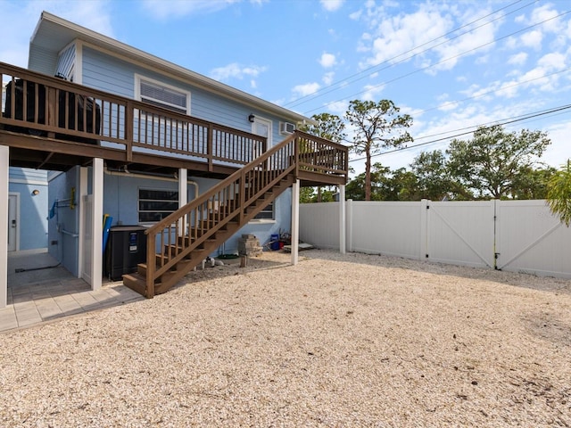 842 Nokomis Ave S, Venice, FL 34285 - back of house featuring a gate, a wooden deck, stairs, and central AC