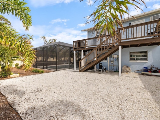 842 Nokomis Ave S, Venice, FL 34285 - rear view of house featuring a lanai, a deck, stairway, and stucco siding