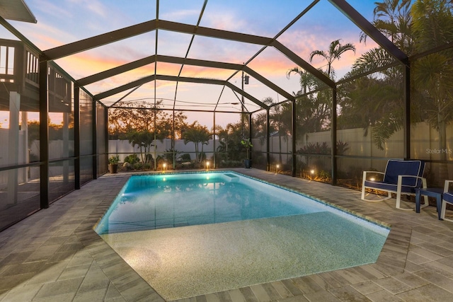 view of pool featuring a fenced in pool, glass enclosure, and a patio