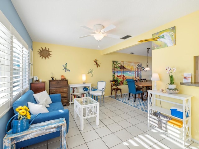 tiled living room with ceiling fan