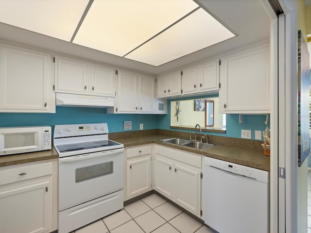 kitchen featuring sink, white cabinets, light tile patterned flooring, and white appliances