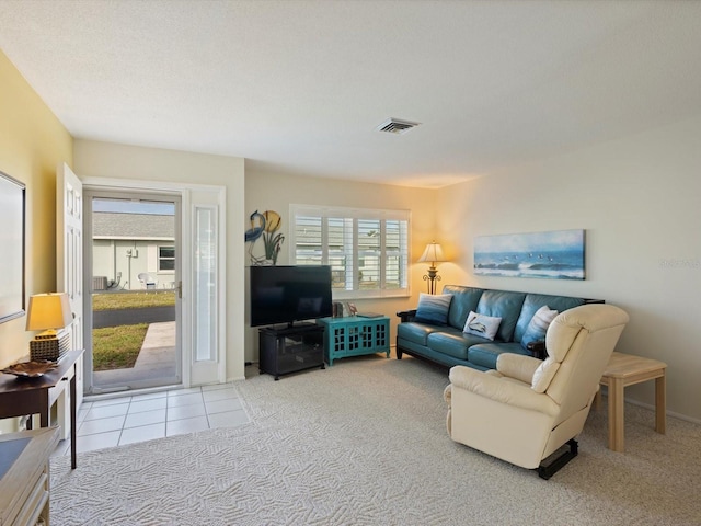 carpeted living room with a textured ceiling