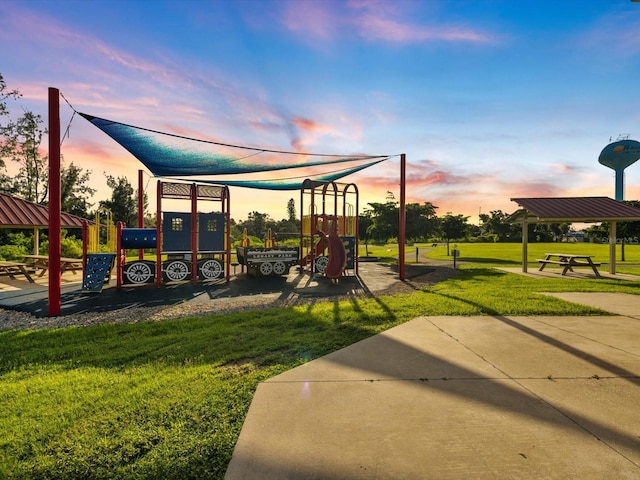 playground at dusk featuring a yard