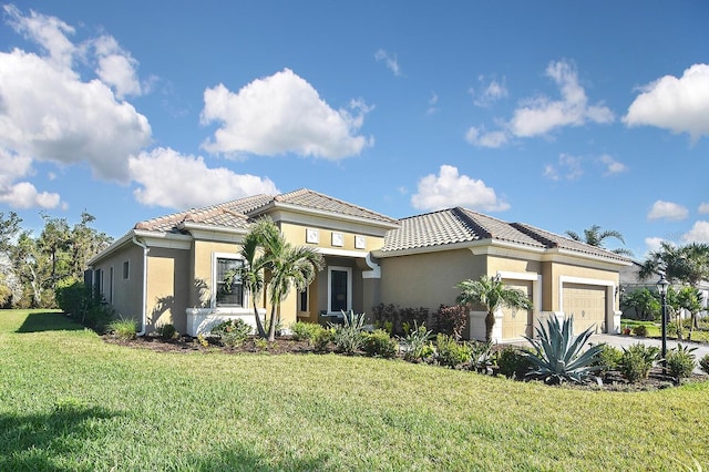 mediterranean / spanish home featuring a front yard and a garage