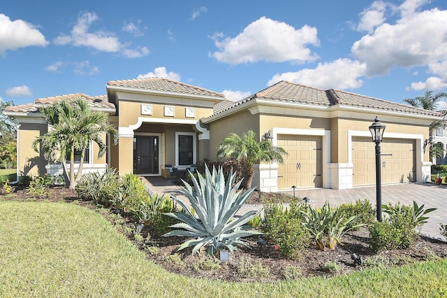 mediterranean / spanish house with a garage