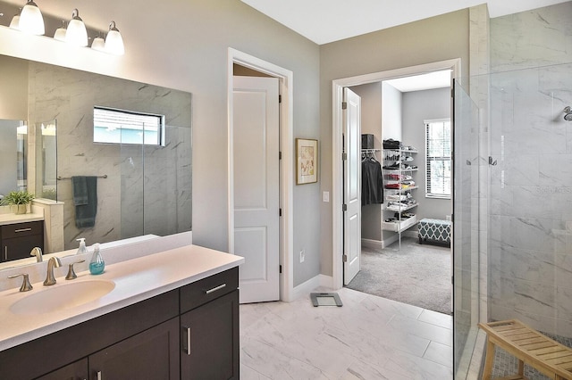 bathroom with vanity and a tile shower