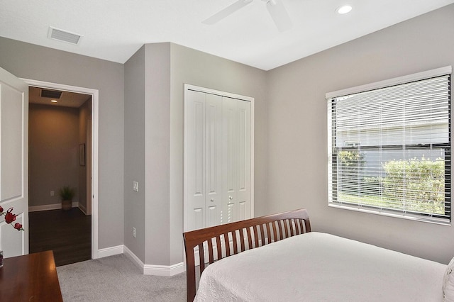 carpeted bedroom featuring a closet and ceiling fan