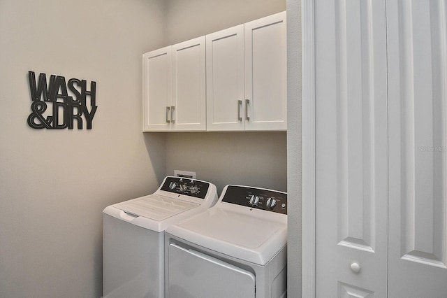 washroom with cabinets and independent washer and dryer