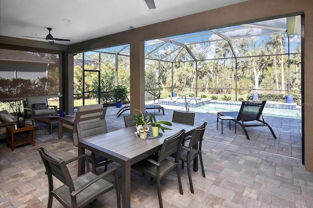 view of patio featuring glass enclosure and ceiling fan