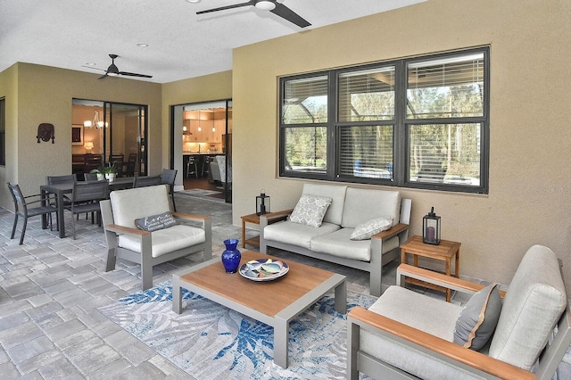 view of patio / terrace with an outdoor living space and ceiling fan