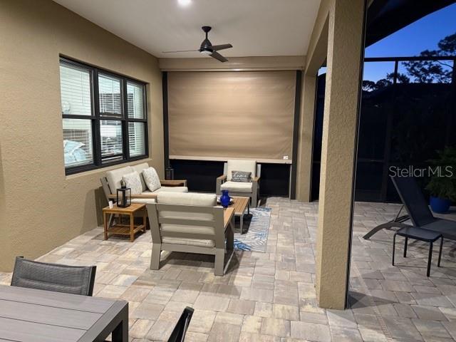 view of patio / terrace with an outdoor hangout area, ceiling fan, and a lanai