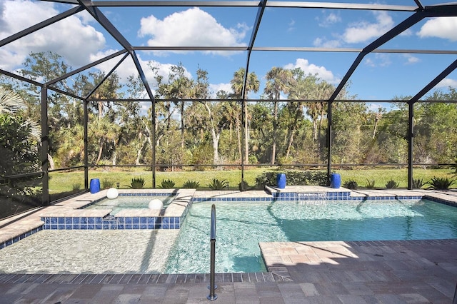 view of swimming pool featuring a lanai, a patio area, and an in ground hot tub