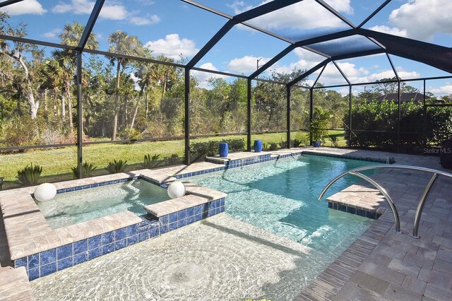 view of pool featuring glass enclosure and an in ground hot tub