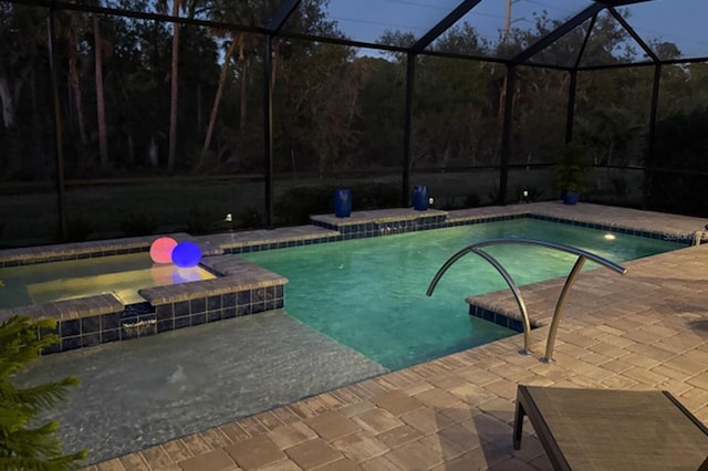 view of swimming pool featuring a lanai and a patio