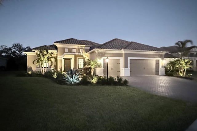 view of front of house with a garage and a front yard