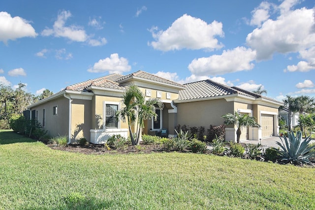 mediterranean / spanish-style home featuring a front lawn and a garage