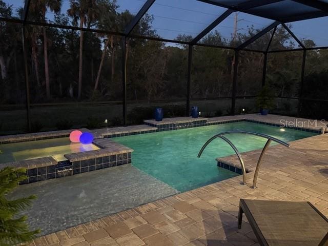 169 N Cayman Isles Blvd, Englewood, FL 34223 - view of swimming pool featuring a patio area, glass enclosure, and a pool with connected hot tub