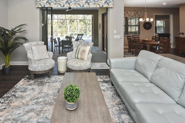 169 N Cayman Isles Blvd, Englewood, FL 34223 - living room featuring wood finished floors, a chandelier, and baseboards
