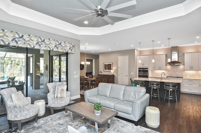 169 N Cayman Isles Blvd, Englewood, FL 34223 - living area with recessed lighting, dark wood-style flooring, a tray ceiling, ceiling fan, and ornamental molding