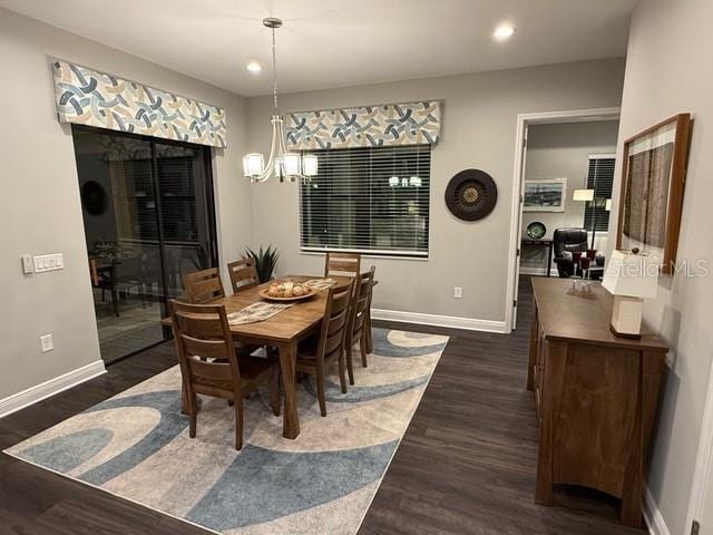 169 N Cayman Isles Blvd, Englewood, FL 34223 - dining space featuring baseboards, dark wood-type flooring, recessed lighting, and a chandelier