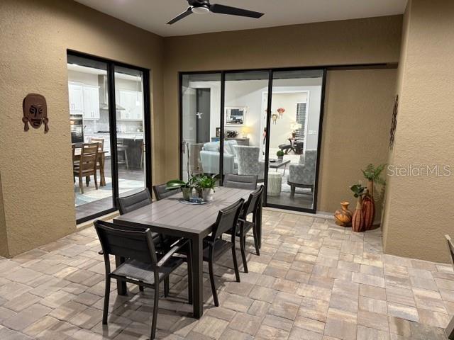 169 N Cayman Isles Blvd, Englewood, FL 34223 - dining room with ceiling fan and a textured wall