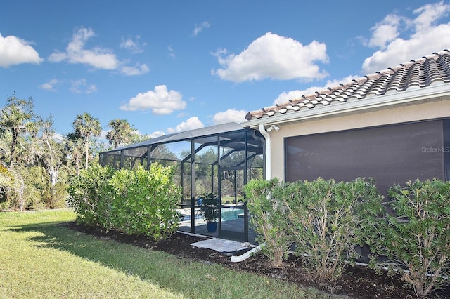 169 N Cayman Isles Blvd, Englewood, FL 34223 - view of green lawn with an outdoor pool, glass enclosure, and an attached garage