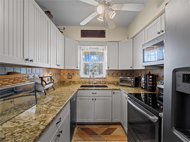 kitchen with tasteful backsplash, white cabinetry, sink, and stainless steel appliances