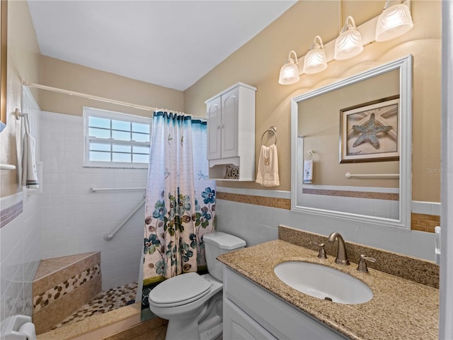 bathroom with vanity, toilet, tile walls, and curtained shower