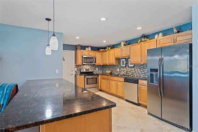 kitchen with decorative backsplash, stainless steel appliances, sink, decorative light fixtures, and dark stone countertops