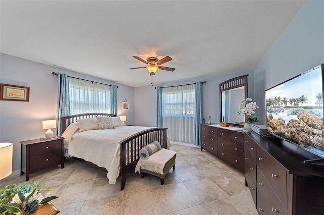 bedroom featuring multiple windows and ceiling fan