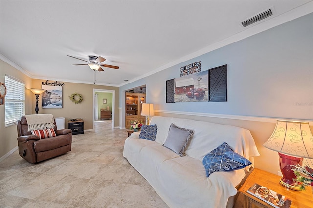 living room featuring ceiling fan and ornamental molding