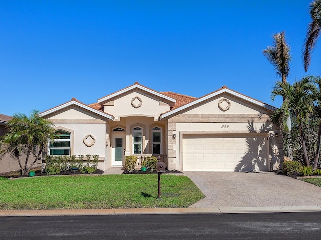 view of front of house with a garage and a front yard