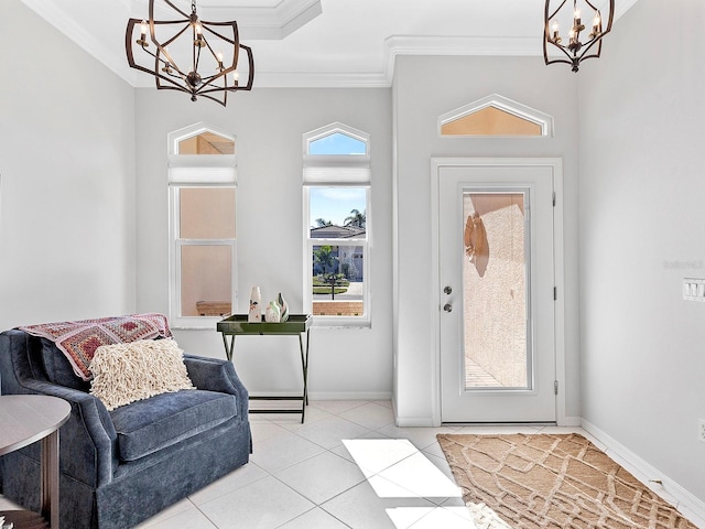 tiled entrance foyer featuring crown molding, plenty of natural light, and a notable chandelier