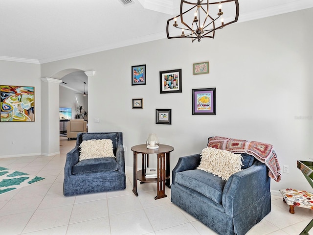 sitting room featuring a chandelier, decorative columns, tile patterned floors, and ornamental molding