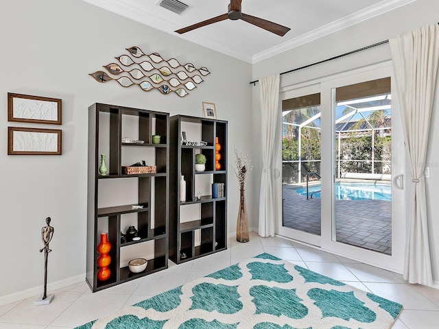 doorway featuring ceiling fan, crown molding, and light tile patterned flooring