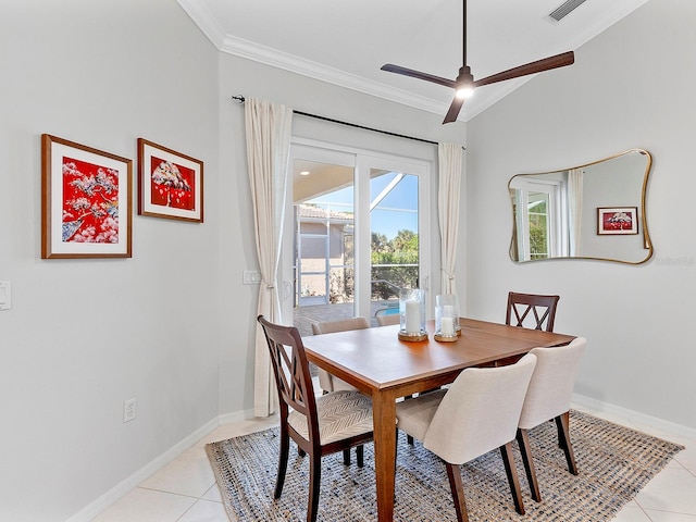 dining room with ceiling fan, light tile patterned floors, ornamental molding, and lofted ceiling