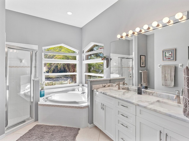 bathroom with tile patterned flooring, vanity, and plus walk in shower