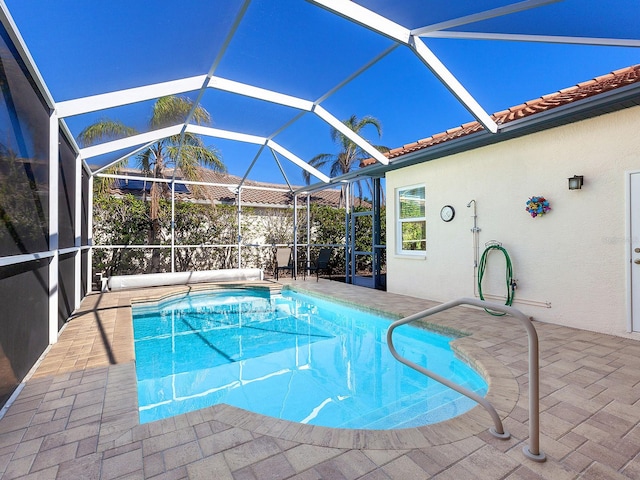 view of swimming pool with a lanai and a patio area