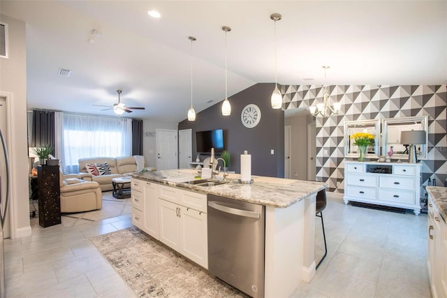 kitchen featuring vaulted ceiling, dishwasher, white cabinets, and decorative light fixtures