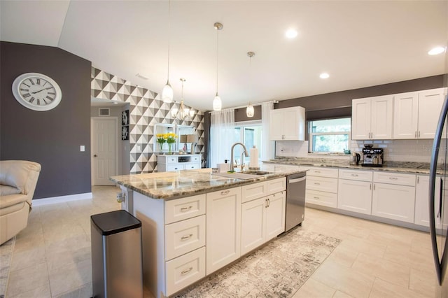 kitchen with white cabinets, sink, pendant lighting, dishwasher, and an island with sink