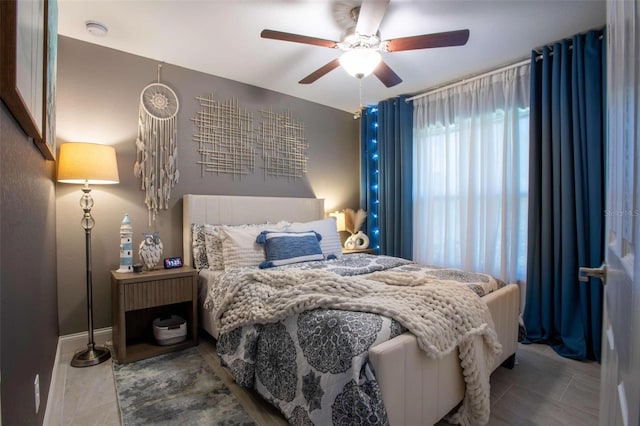 bedroom featuring tile patterned floors and ceiling fan