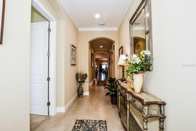 hall with light wood-type flooring and crown molding