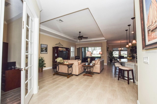 living room with french doors, ceiling fan, and ornamental molding