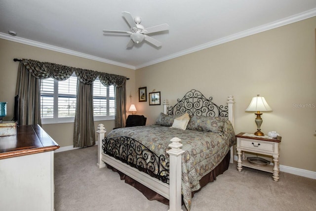 carpeted bedroom with ceiling fan and crown molding